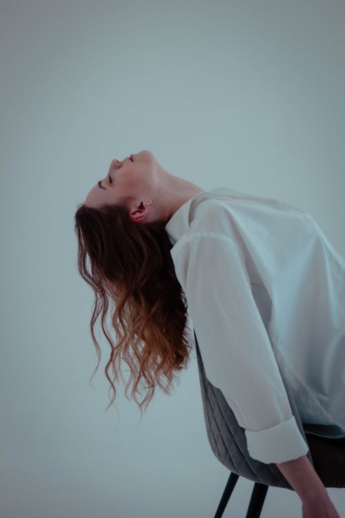 Woman Sitting on Chair and Posing