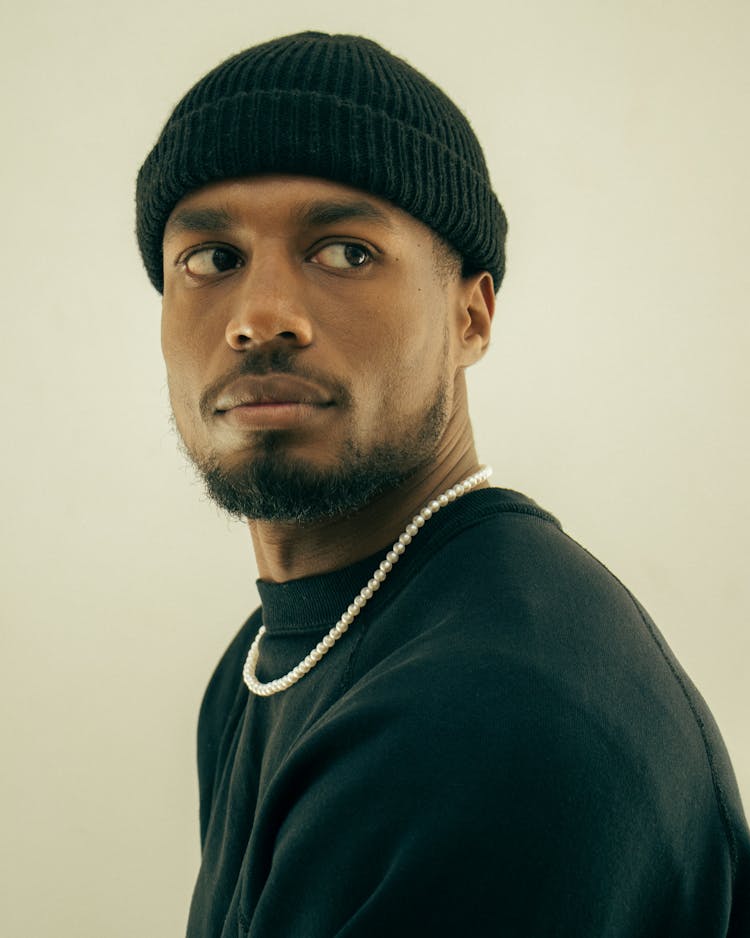 Young Man In Hat On Light Background