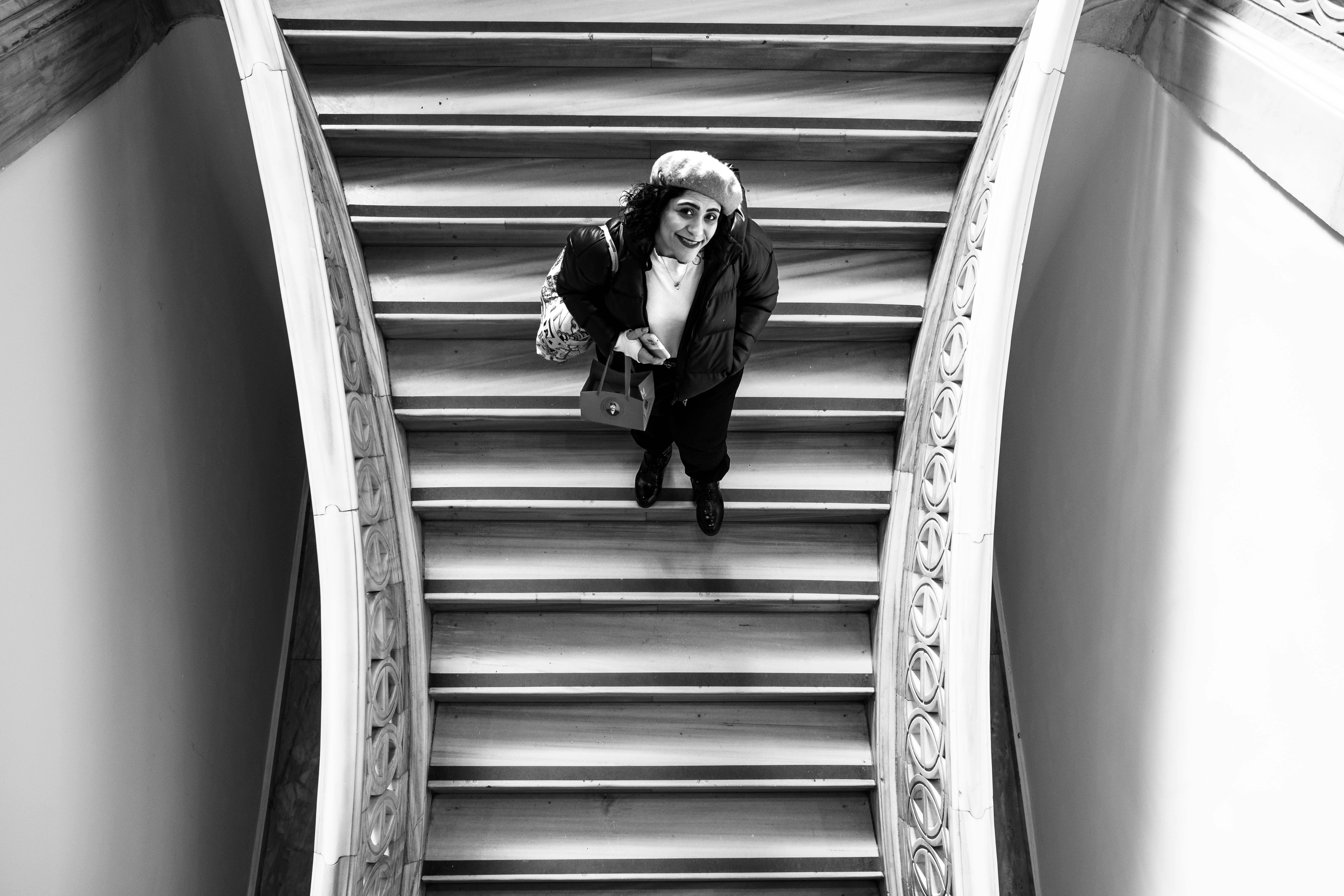 오디움 박물관 바로가기 (audeum.org) Black and white photograph of a woman on a wooden staircase in an Istanbul museum.