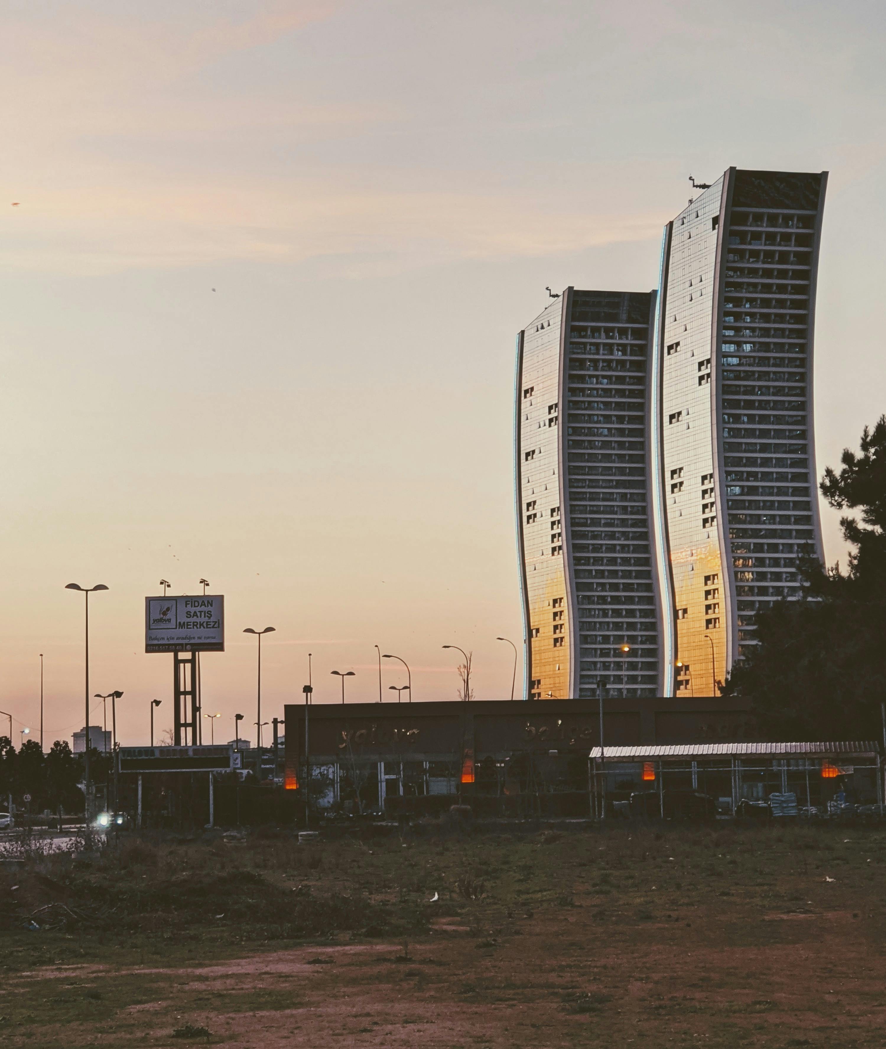 Stunning view of modern skyscrapers reflecting sunset hues in Istanbul's urban landscape.