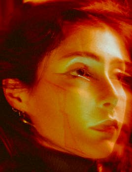 An artistic portrait of a woman with expressive lighting, creating a moody and abstract feel.