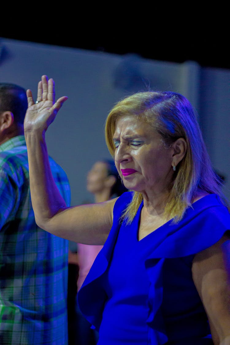 Crying Woman In Blue Dress Raising Hand Up