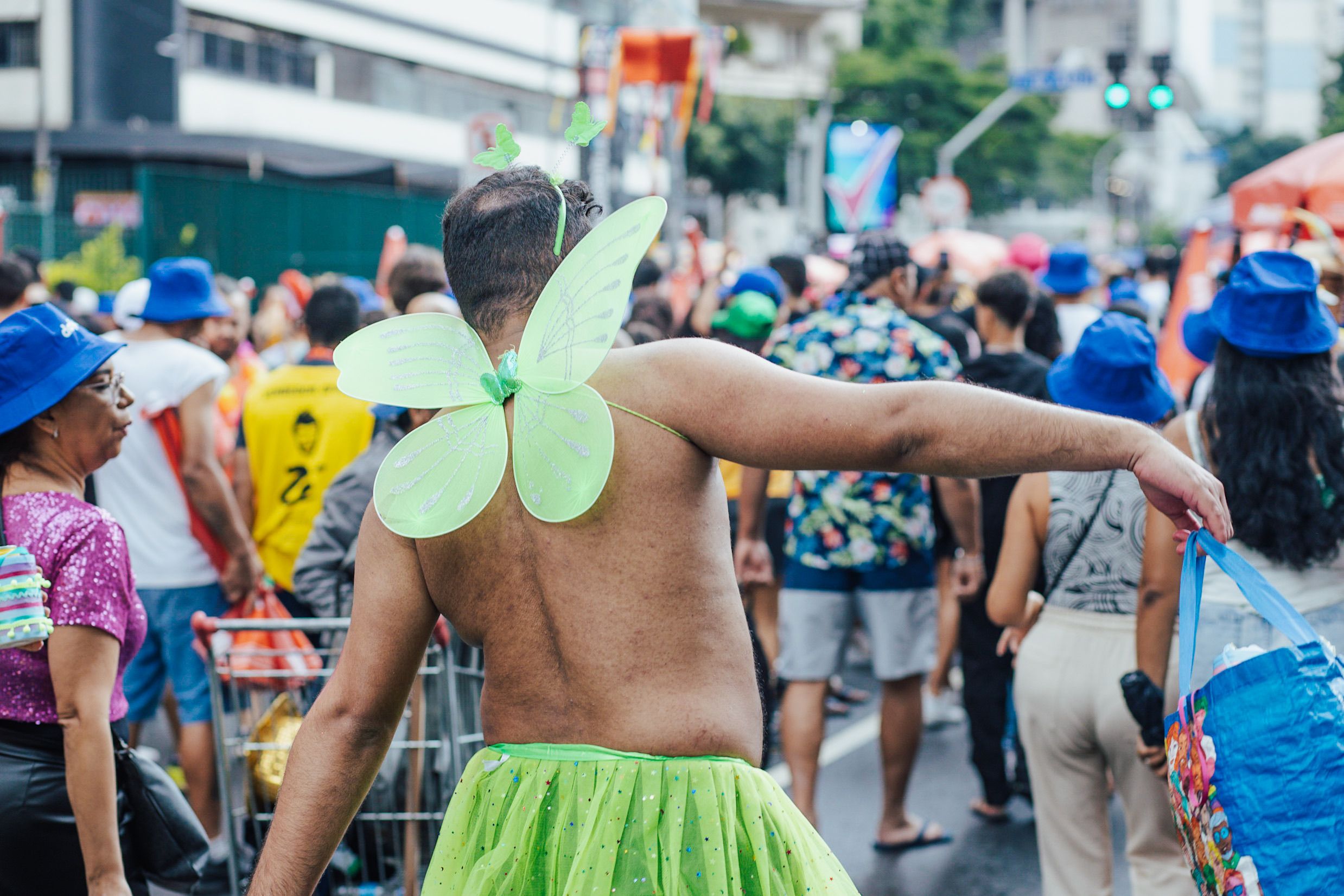 Vibrant festival parade in São Paulo with attendees in colorful costumes, celebrating joyfully.
