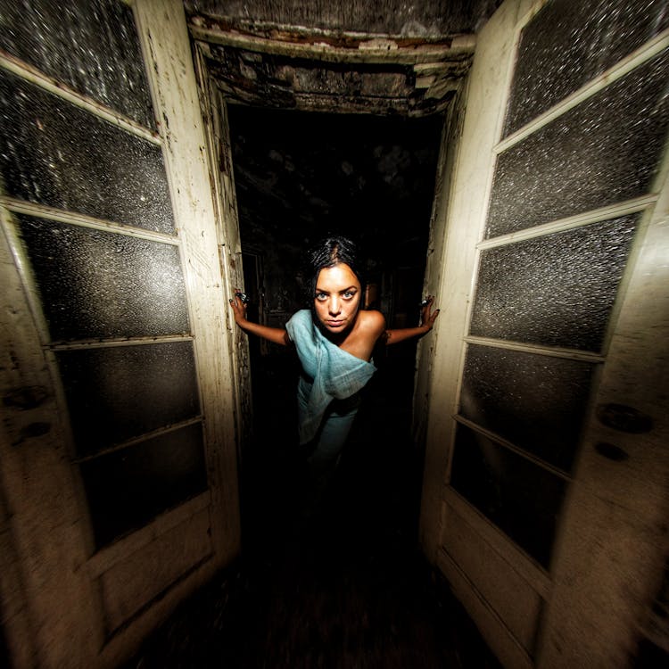 Woman Walking Through Old Wooden Door