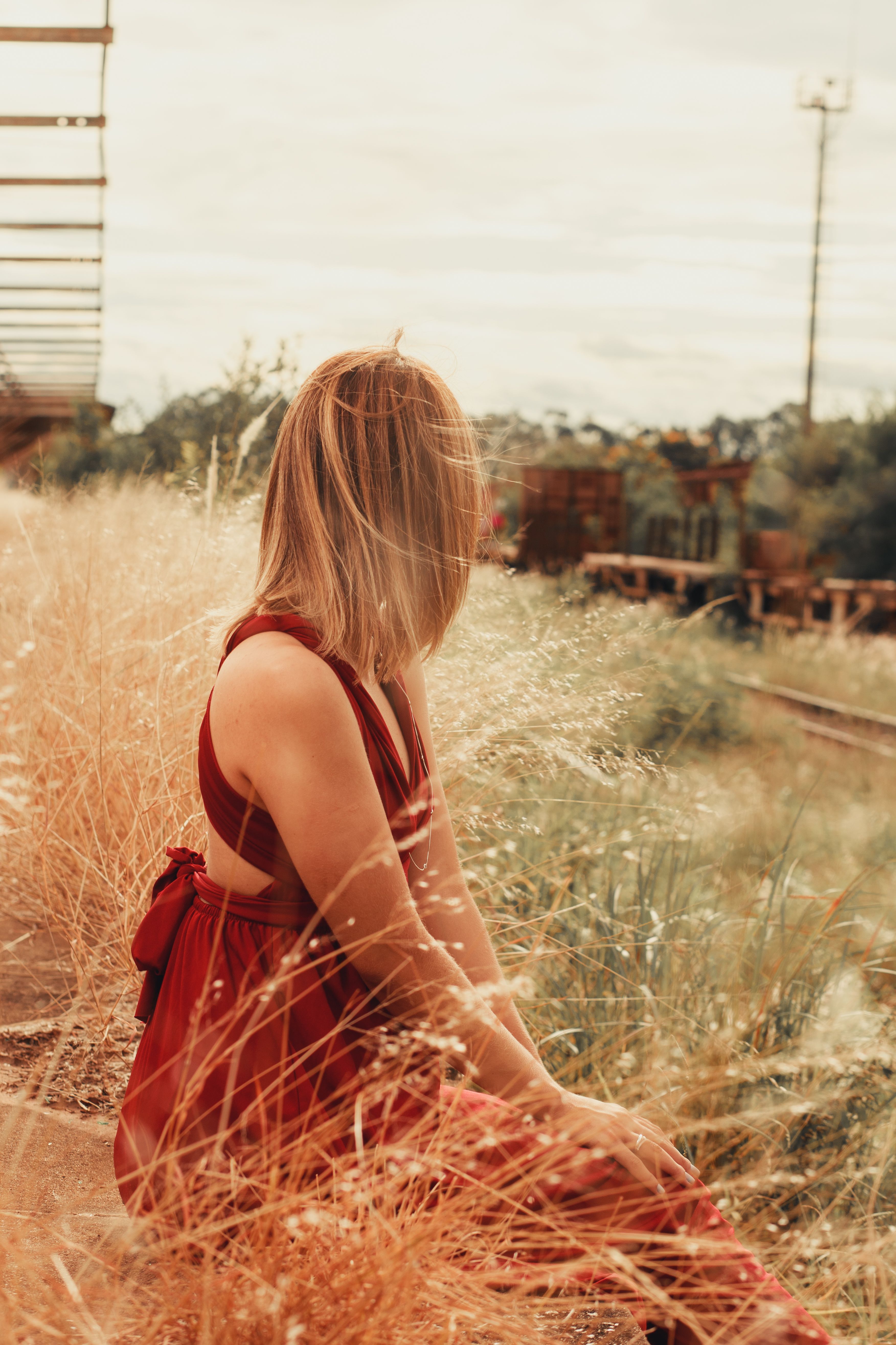 Woman in Red Dress Sitting in Field · Free Stock Photo