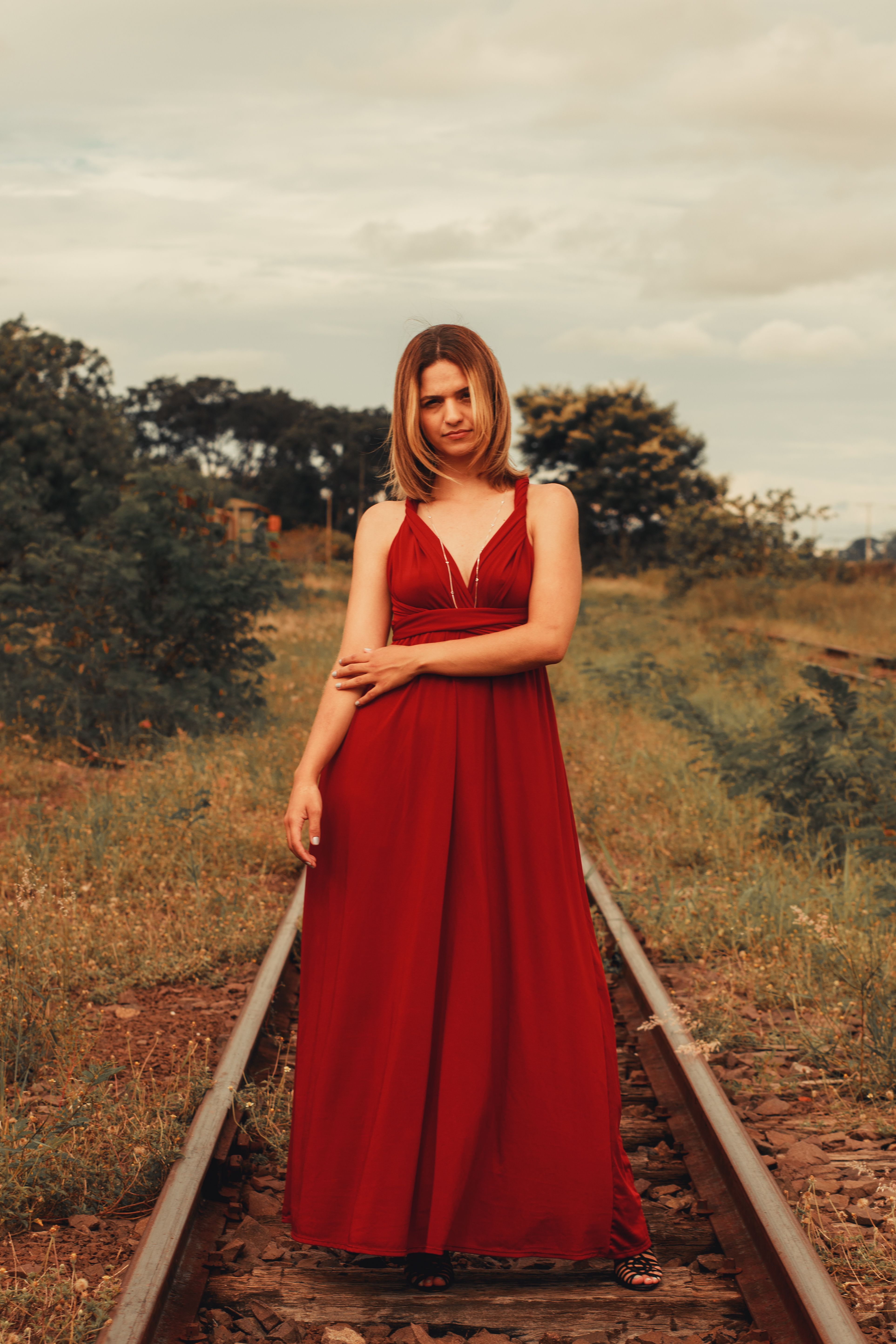 A Woman in Red Dress Standing Near a Pyramid · Free Stock Photo