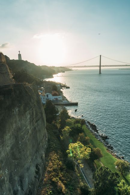 Breathtaking aerial view of Lisbon's 25 de Abril Bridge over the Tagus River at sunset.