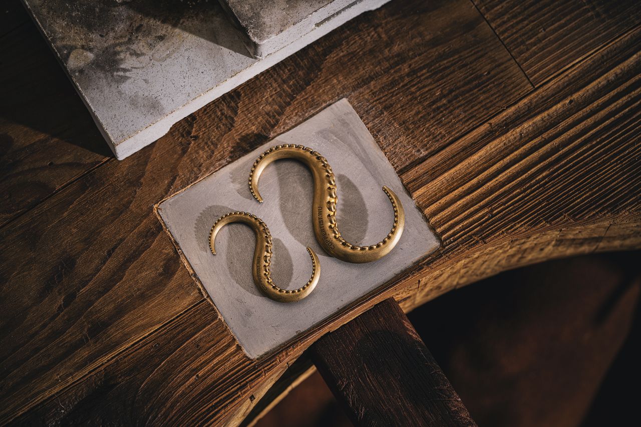 a vintage wooden desk with a gold octopus like ornament evoking antiqu
