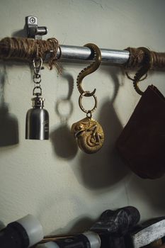 Close-up of a vintage octopus hanger holding items on an industrial rod.