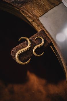 Close-up of ornate brass tentacle hooks with an art deco style, offering a nostalgic and vintage feel.