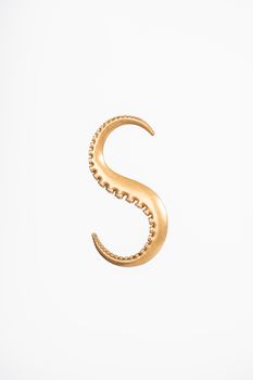 Close-up of a brass octopus tentacle hook, evoking a vintage and art deco style, on a white backdrop.