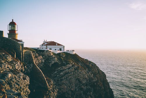 Free Lighthouse on Cliff Beside Body of Water Stock Photo