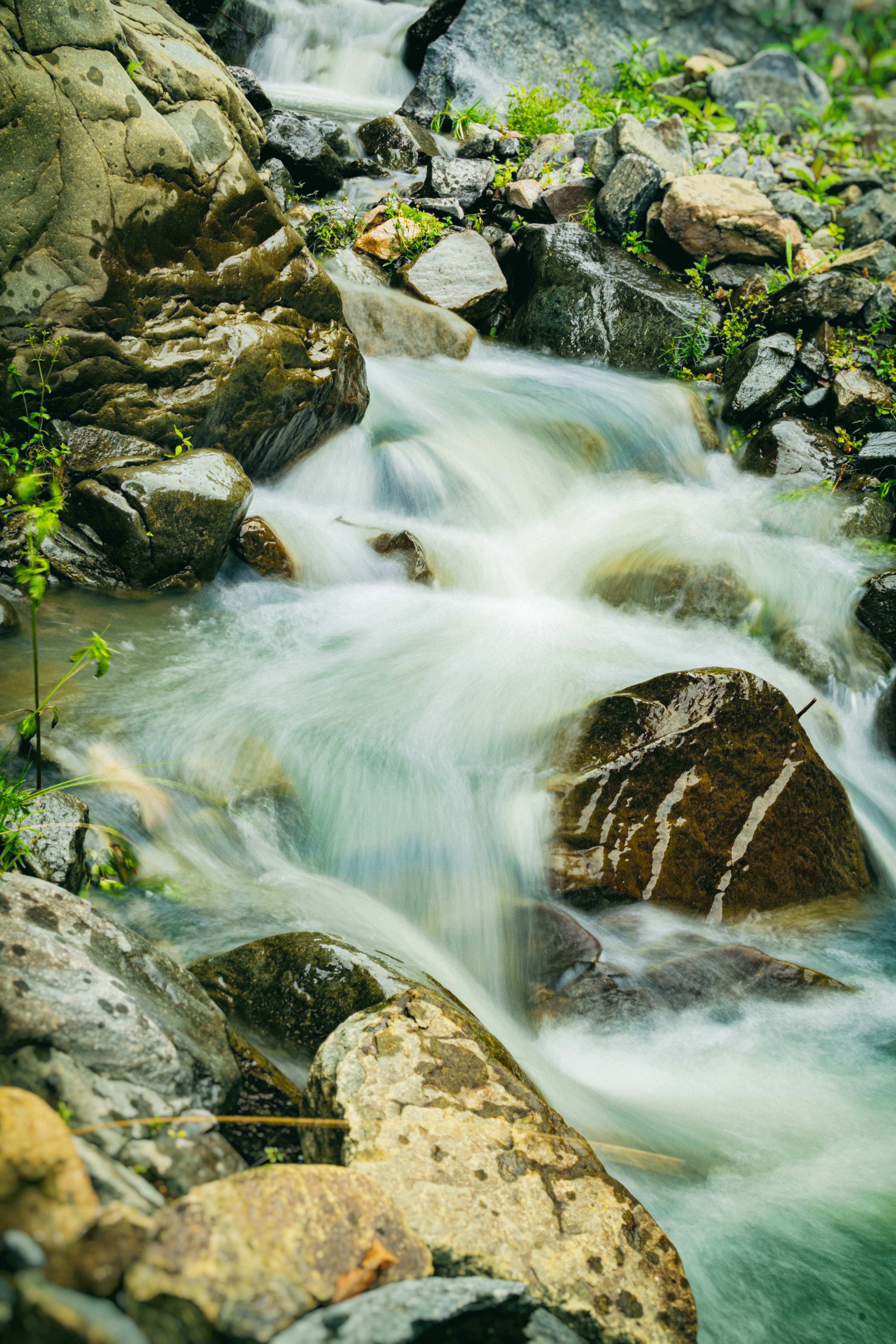 Close up of Flowing Water over Rocks · Free Stock Photo