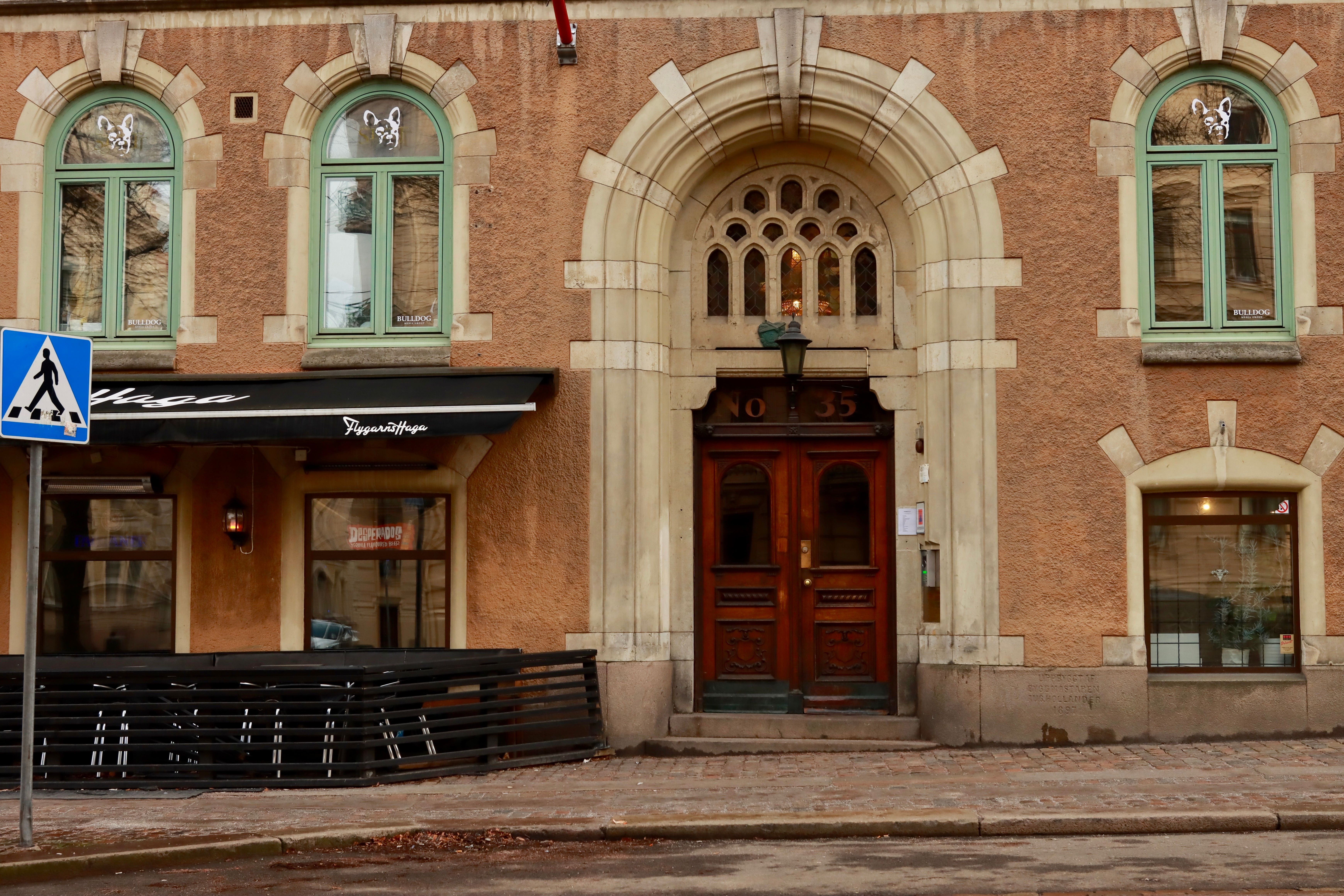 Elegant facade of a historic building featuring arches and wooden doors in Sweden.