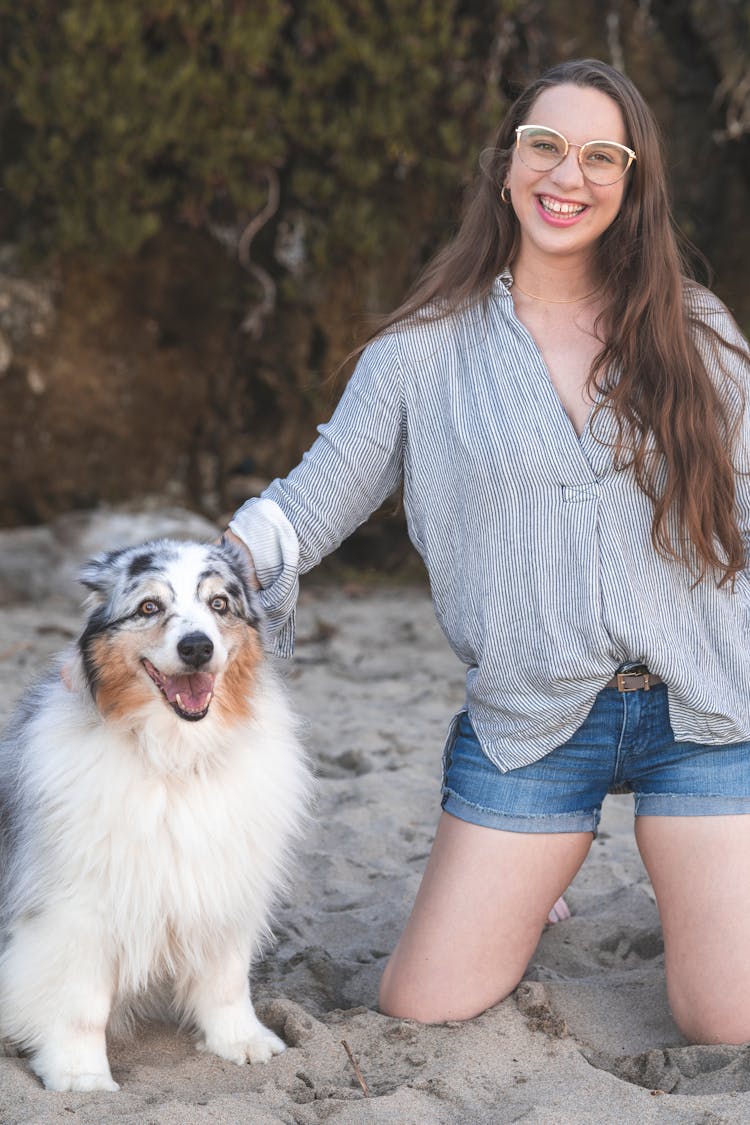 Beautiful Young Woman And Her Aussie Dog At The Beach