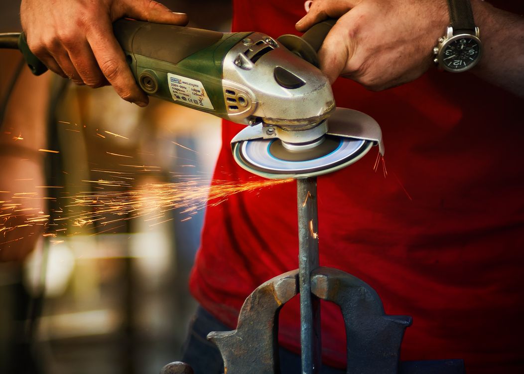 Man Hands Holding Working Grinder · Free Stock Photo