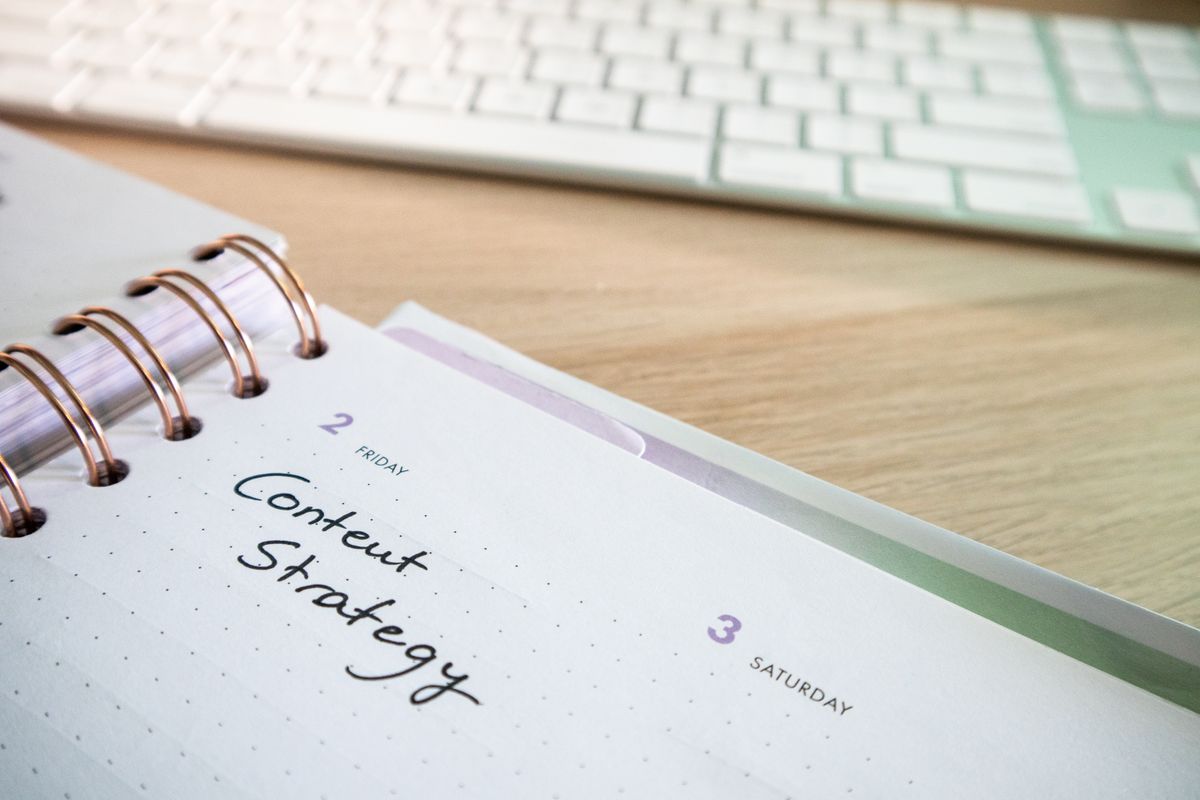 Planner with 'Content Strategy' handwritten next to a keyboard