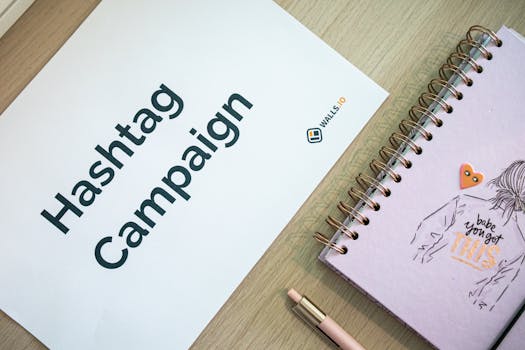 Creative desk setup featuring a hashtag campaign paper and a motivational notebook, ideal for marketing and planning themes.
