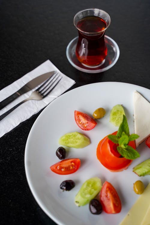 Vegetables on a Plate and a Glass of Tea 