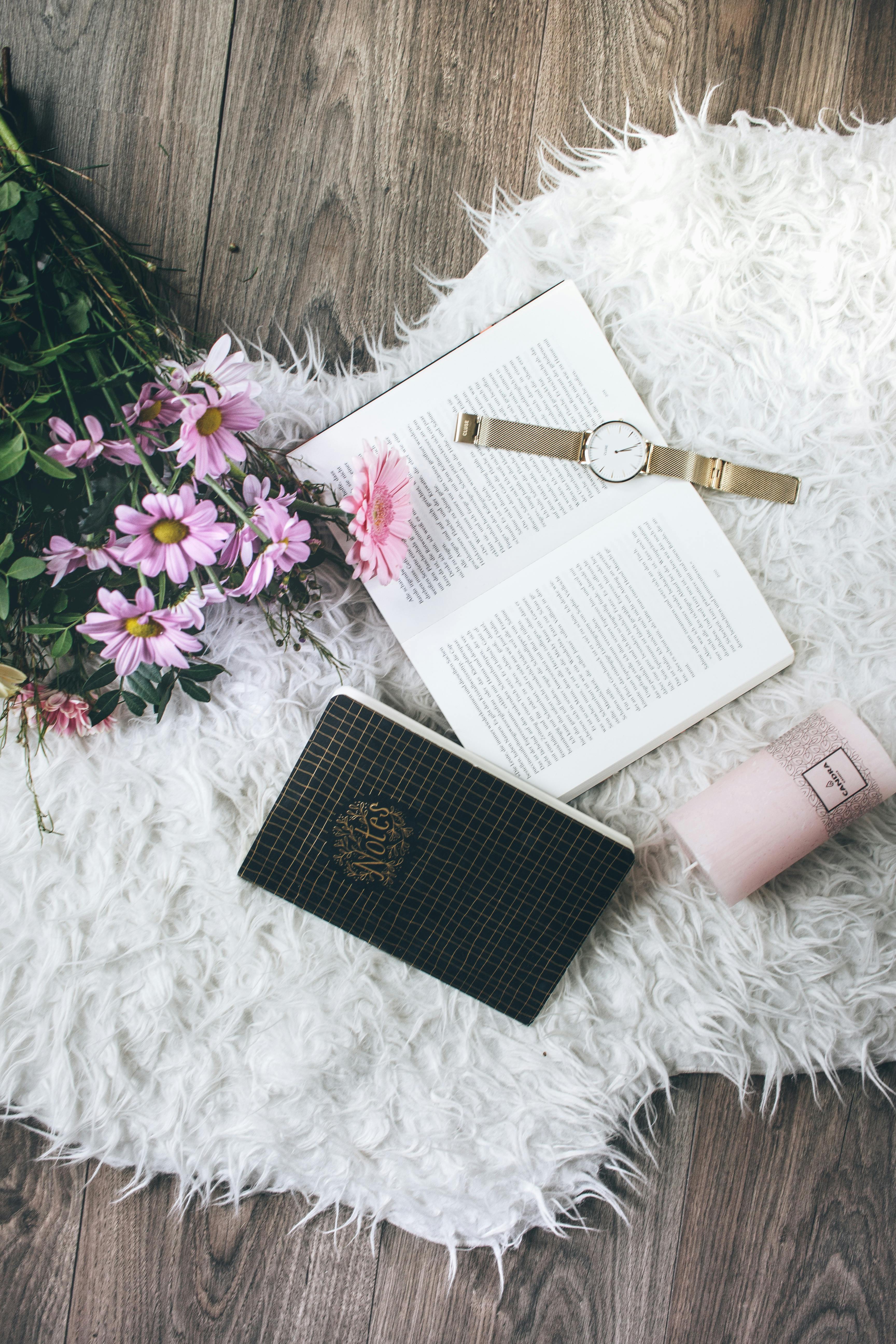 flatlay photo of a watch on book