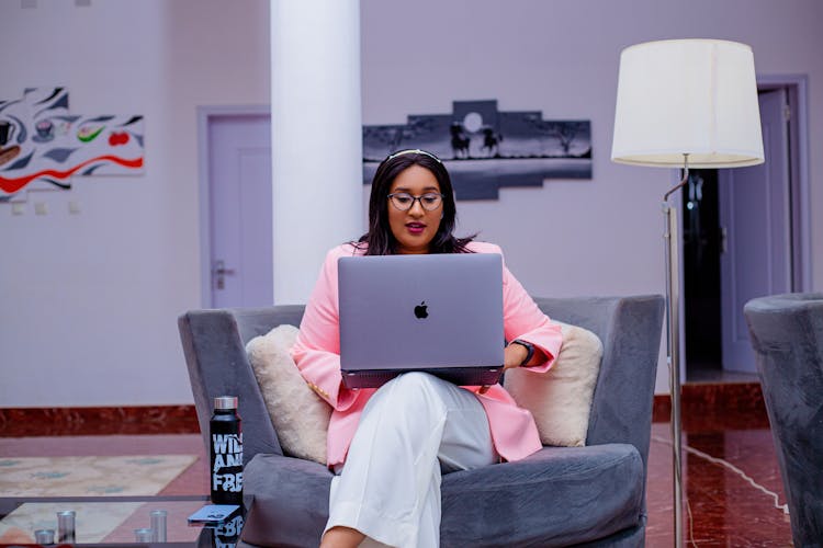 Woman Sitting On A Chair Using A Computer