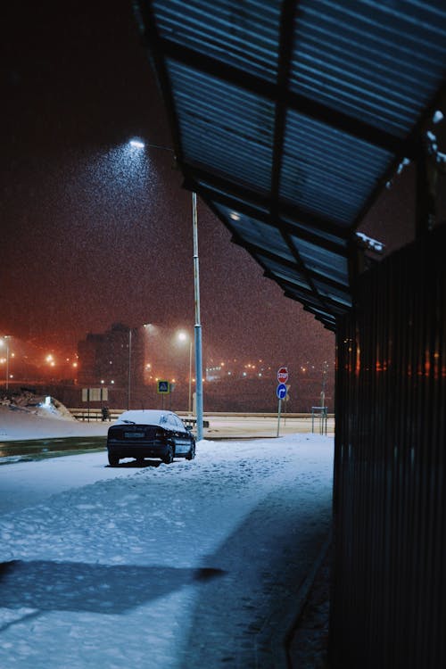 Car on Street in Snow at Night