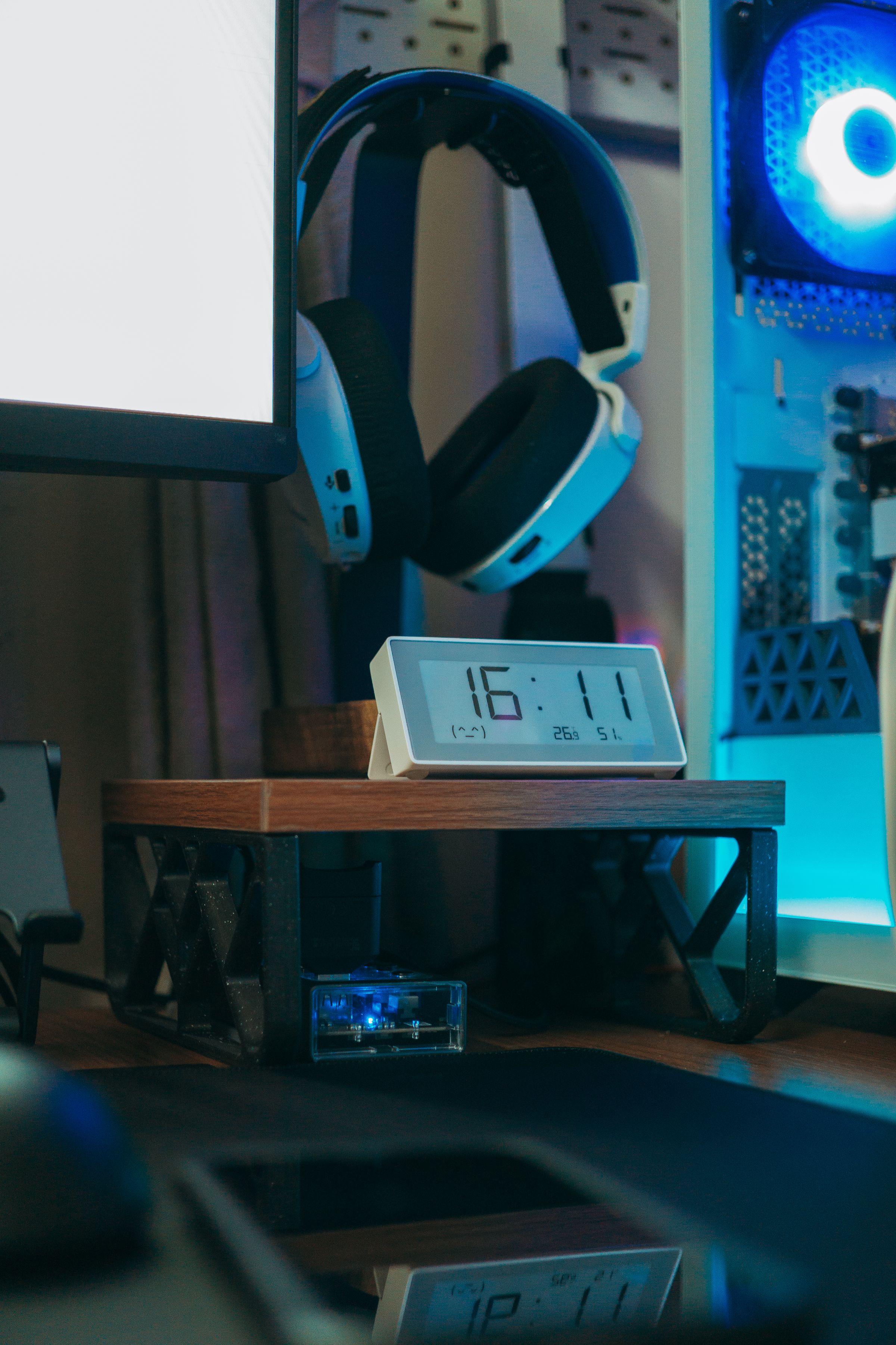 Gaming headset displayed beside a digital desk clock