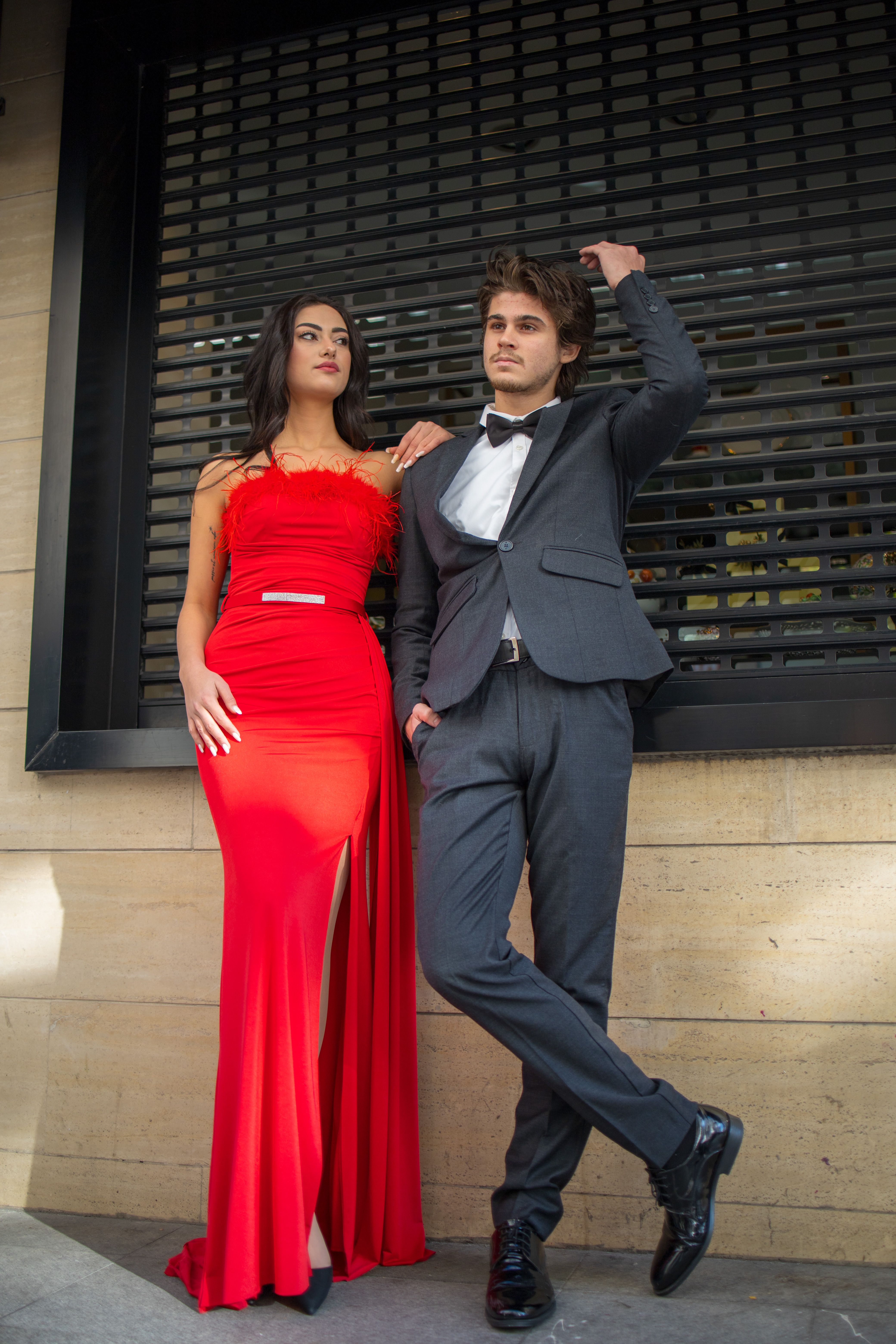 red dress and suit Woman in beautiful red dress and man wearing blue classical suit with bow  tie