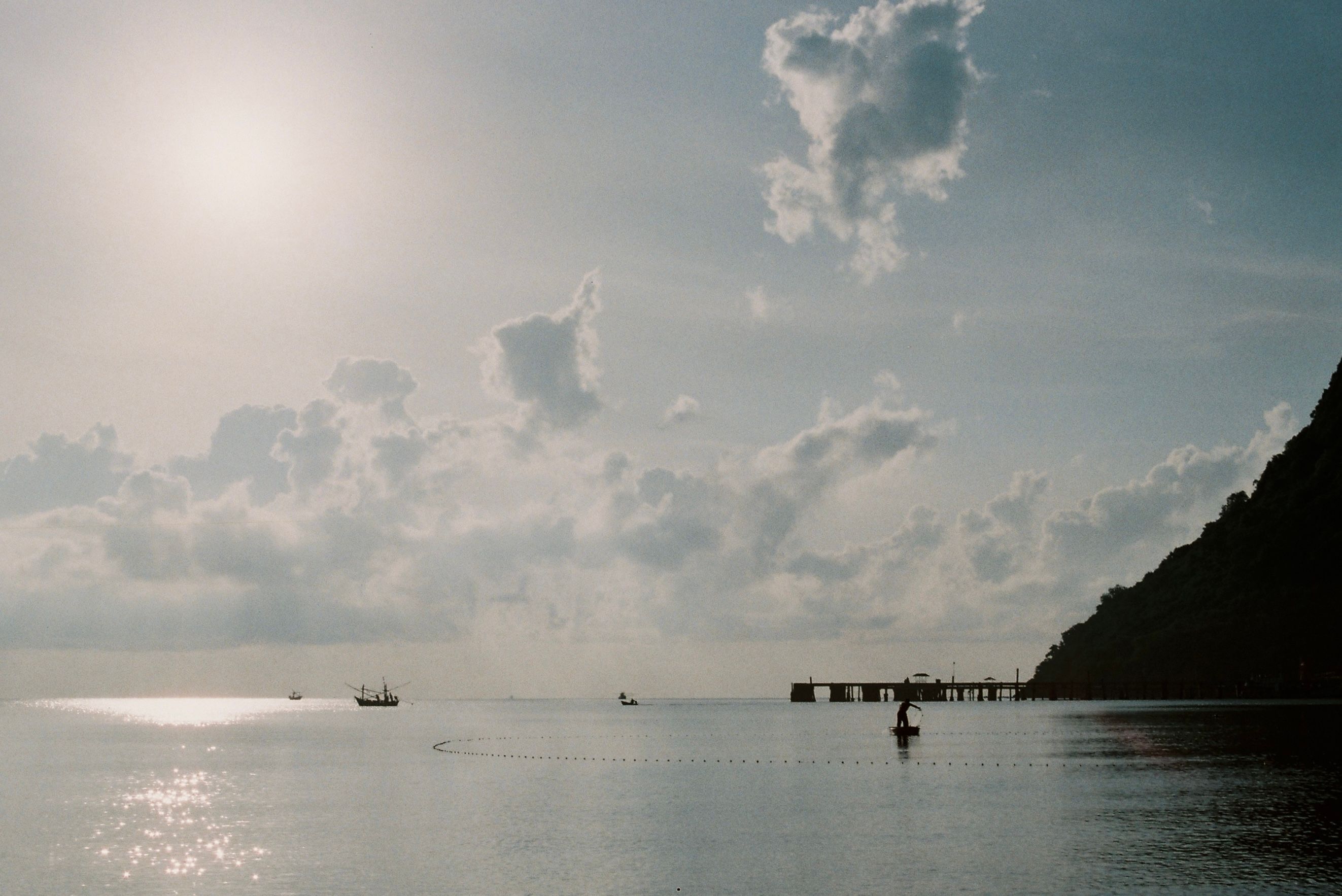 Silhouette of Pier and Boats on Sea under Cloudy Sky · Free Stock Photo