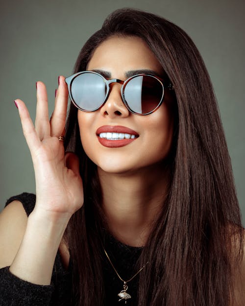Smiling Woman in Sunglasses in Studio