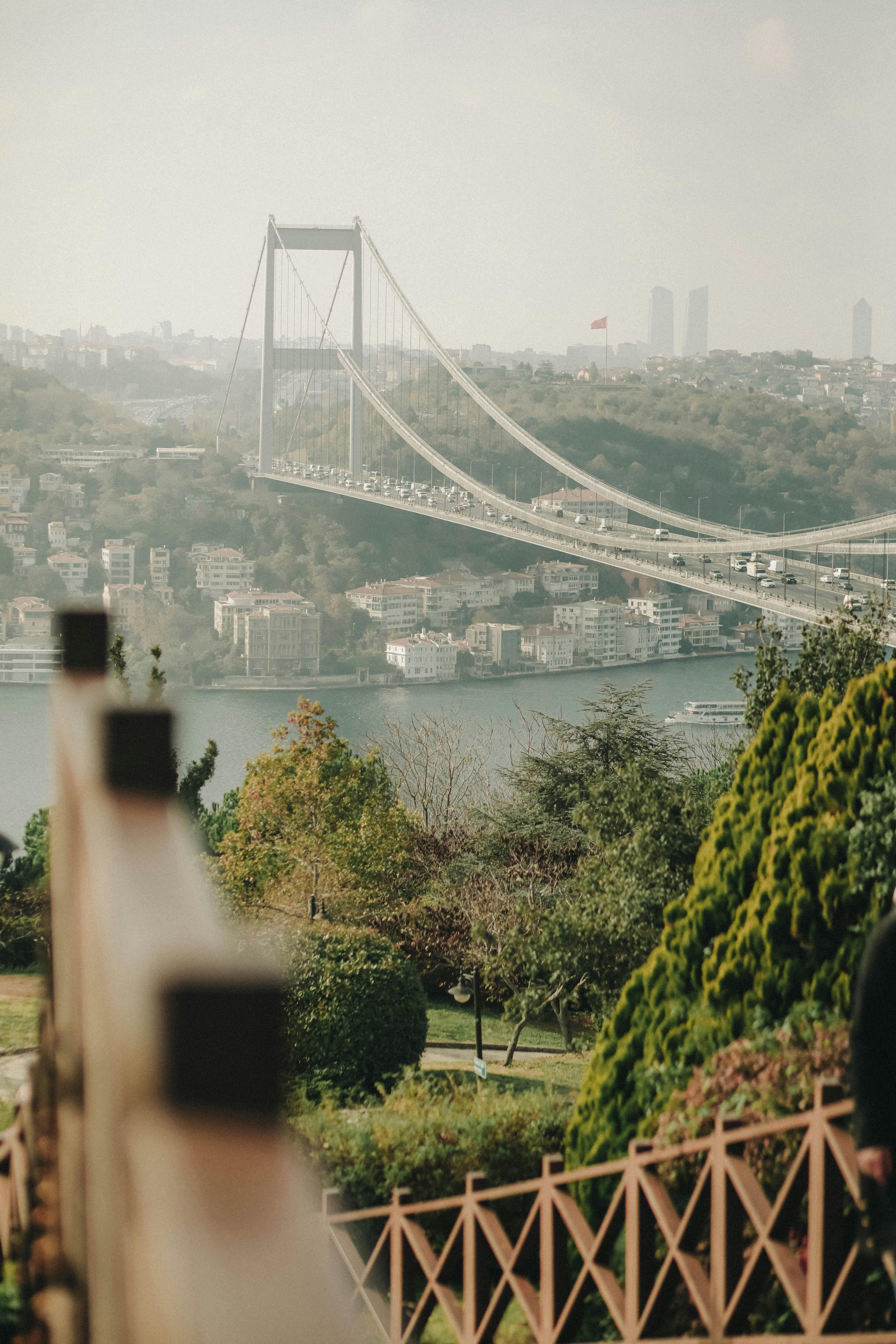 Scenic view of the Bosphorus Bridge spanning across Istanbul, Turkey on a hazy day.