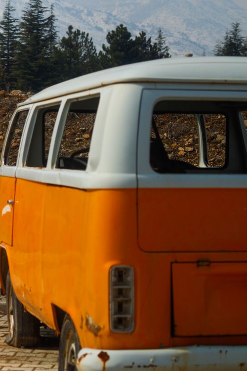 Free Abandoned vintage orange van parked outdoors, perfect for rustic and nostalgic themes. Stock Photo