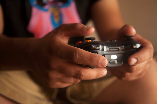 A person holding a wireless game controller indoors, emphasizing relaxed gaming.