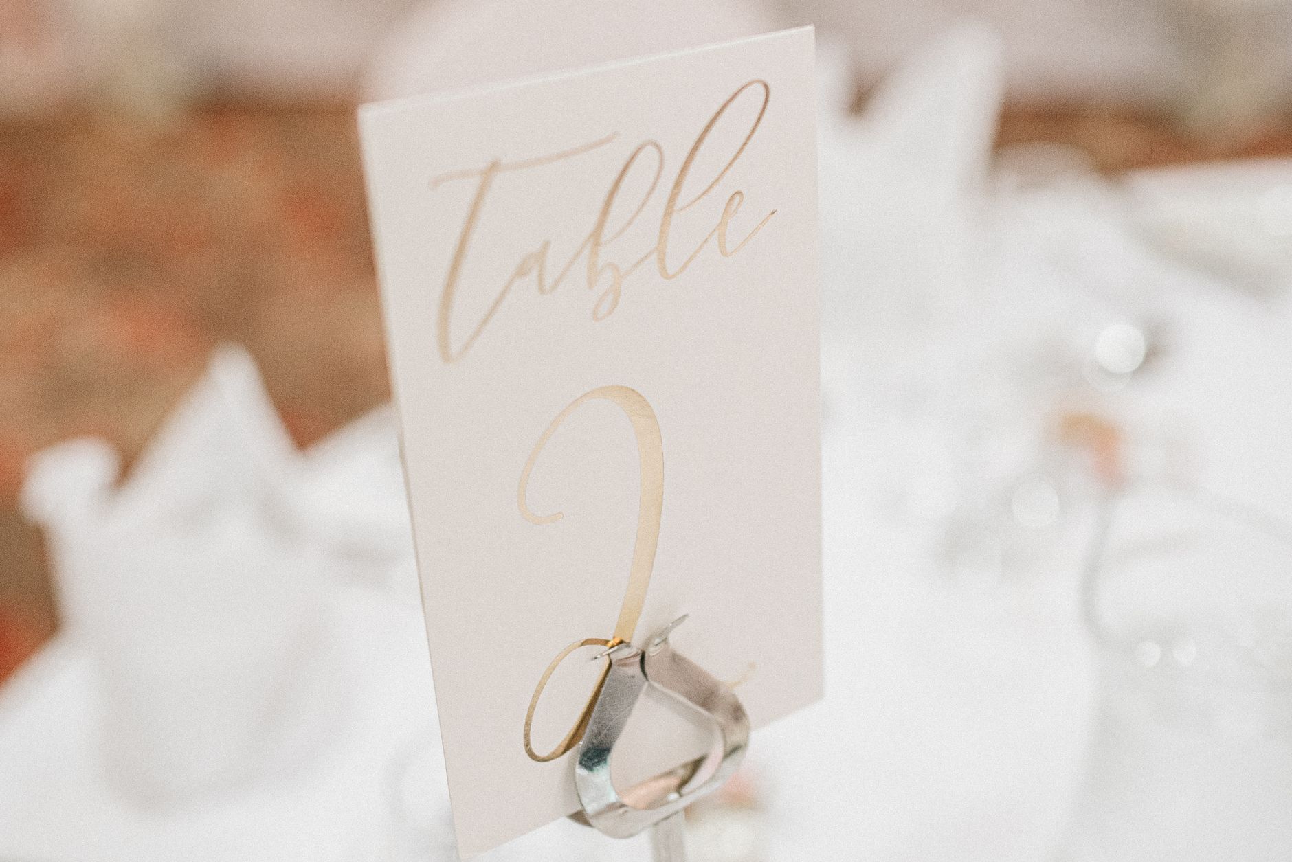 A printed wedding table number with floral styling — the surface most signage templates are designed for