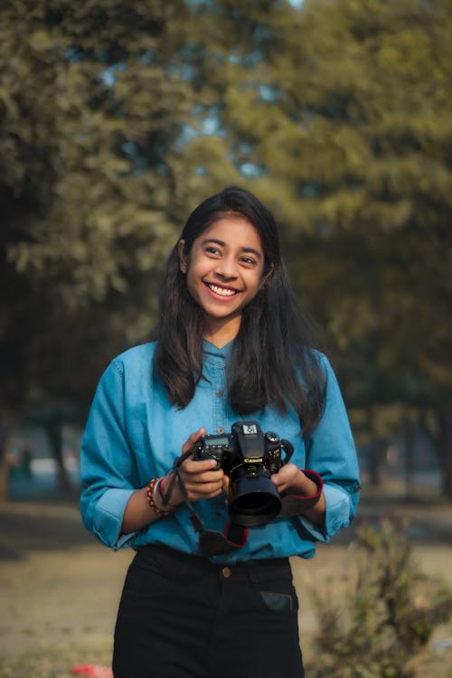 Smiling Young Photographer with a Canon Digital Camera