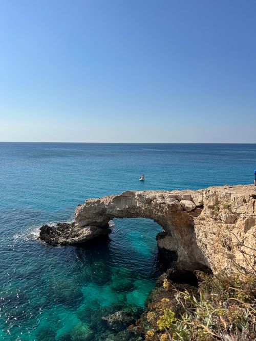 Free Stunning view of a natural stone arch by the turquoise sea at Cape Greco, Cyprus. Stock Photo