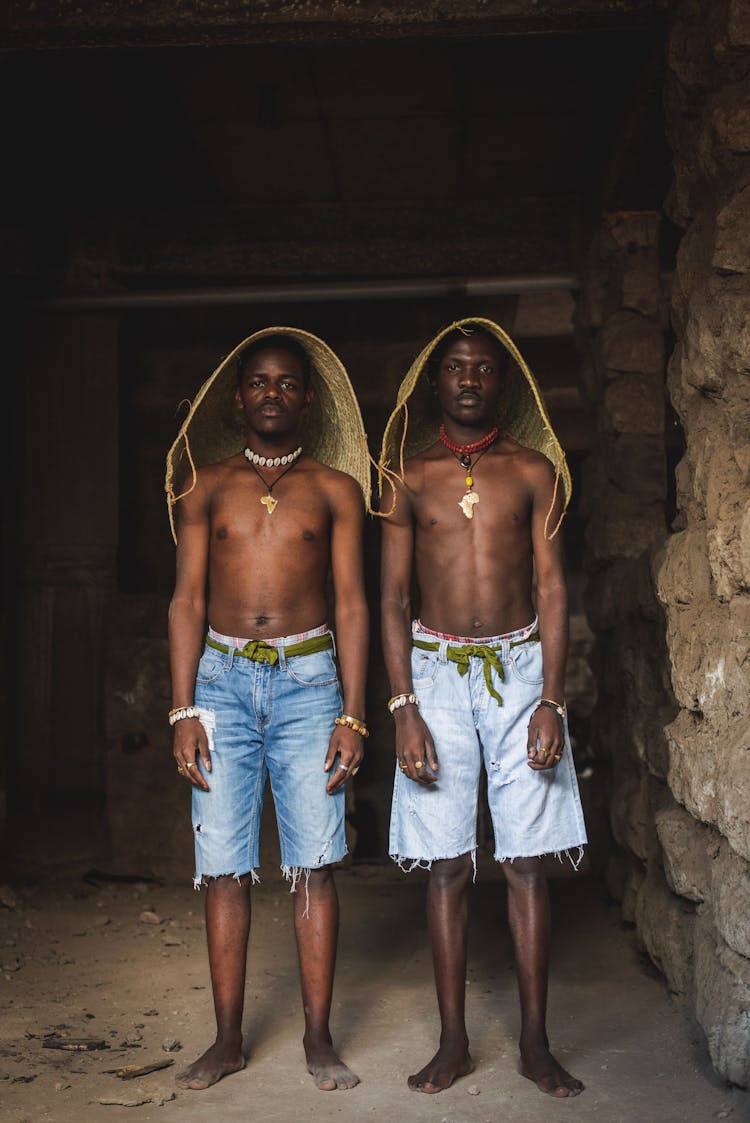 Topless Men With Straw Hats In Abandoned Building