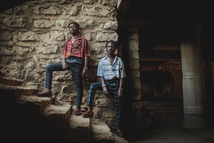 Men In Suits Posing On Stairs In Stone Building