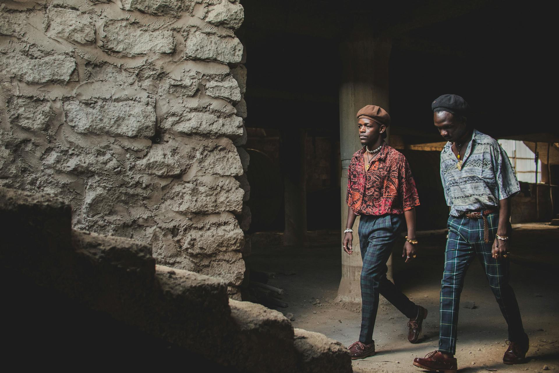 Two stylish men walking through an unfinished building in Nairobi, Kenya.