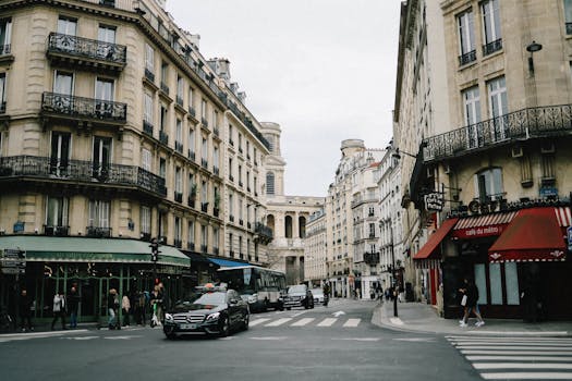 Lively Paris street showcasing classic architecture, busy pedestrians, and iconic French charm.