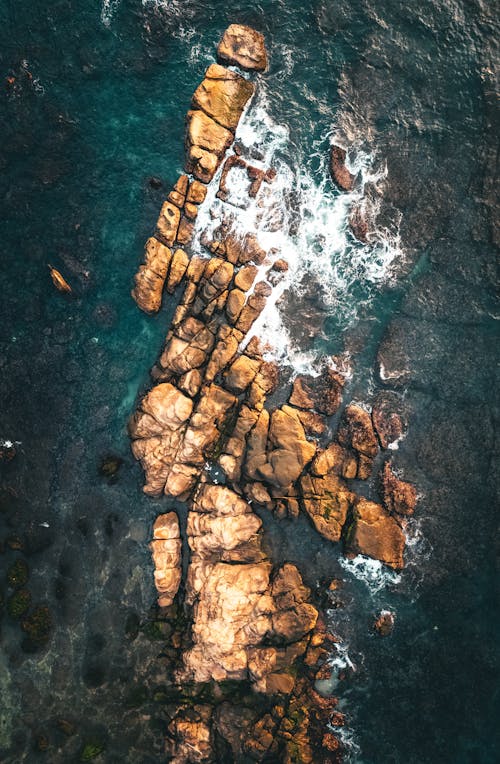Top View of Water Splashing on a Rocky Shore 