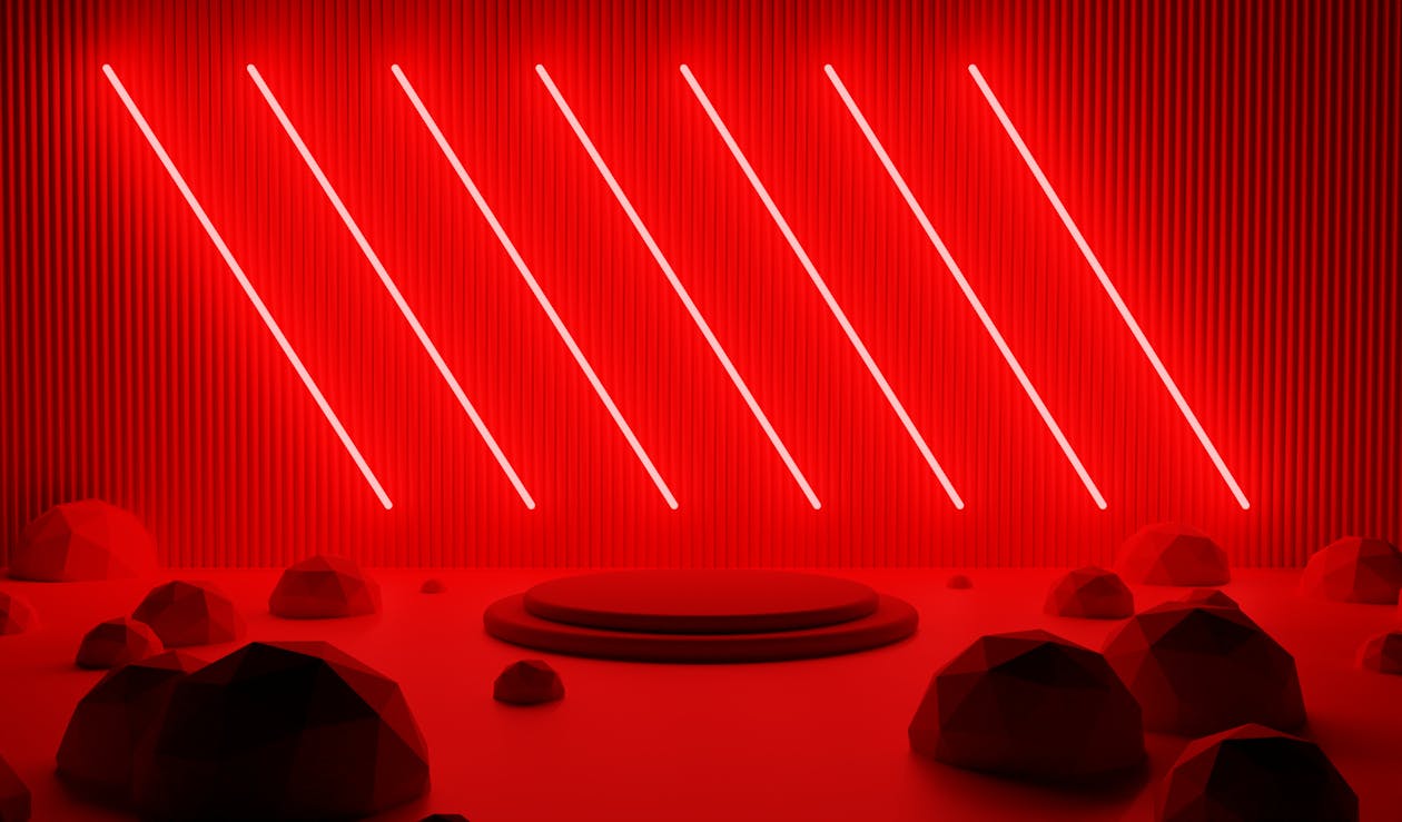 Red neon light in a dark room with rocks · Free Stock Photo