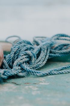 Textured close-up of a tangled blue rope on a rustic surface in Canoa Quebrada, Brazil.
