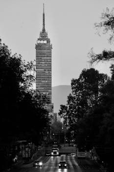 Monochrome view of Mexico City's Torre Latinoamericana with evening traffic.