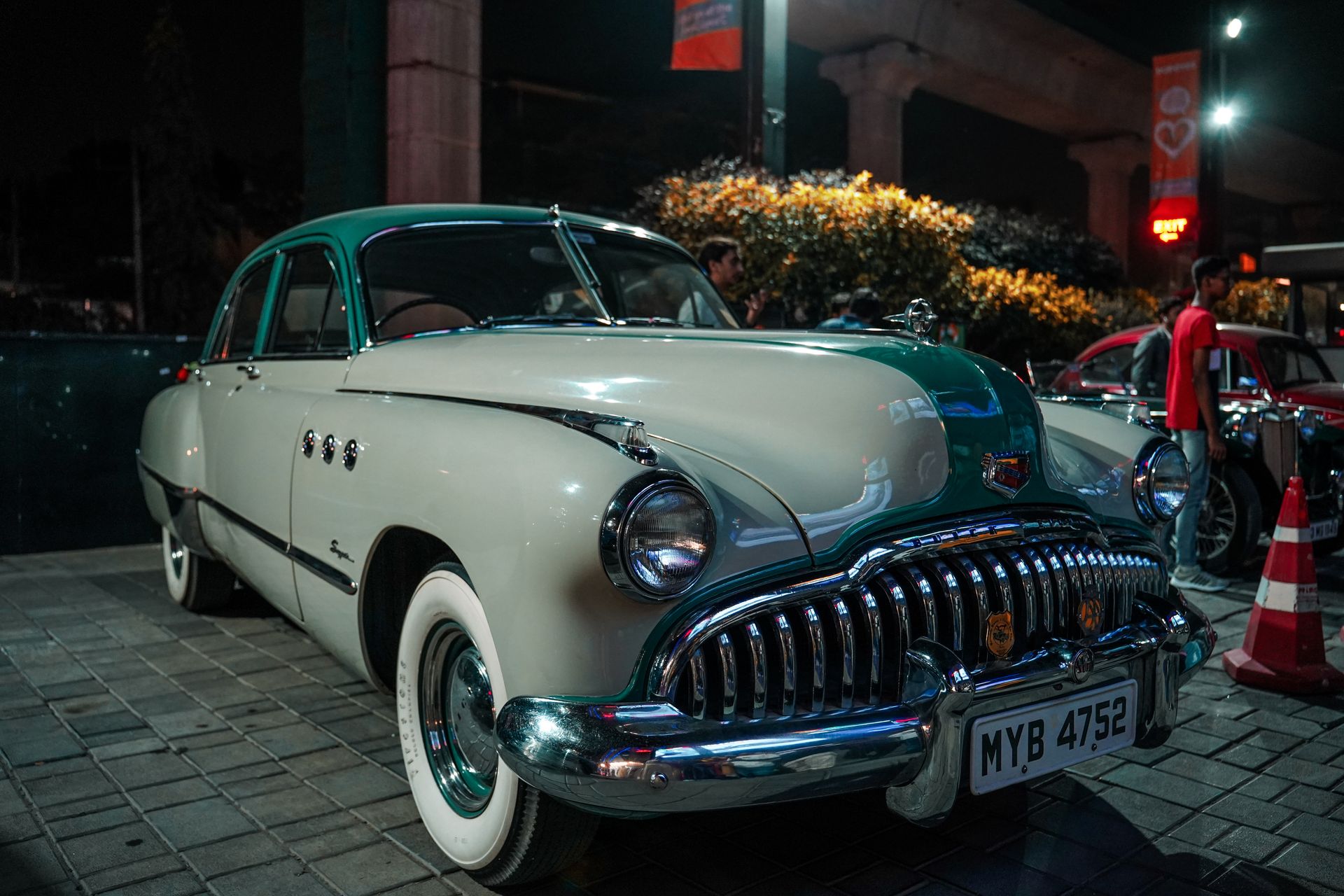 Classic Buick car showcased under night lights. Retro style and timeless design.