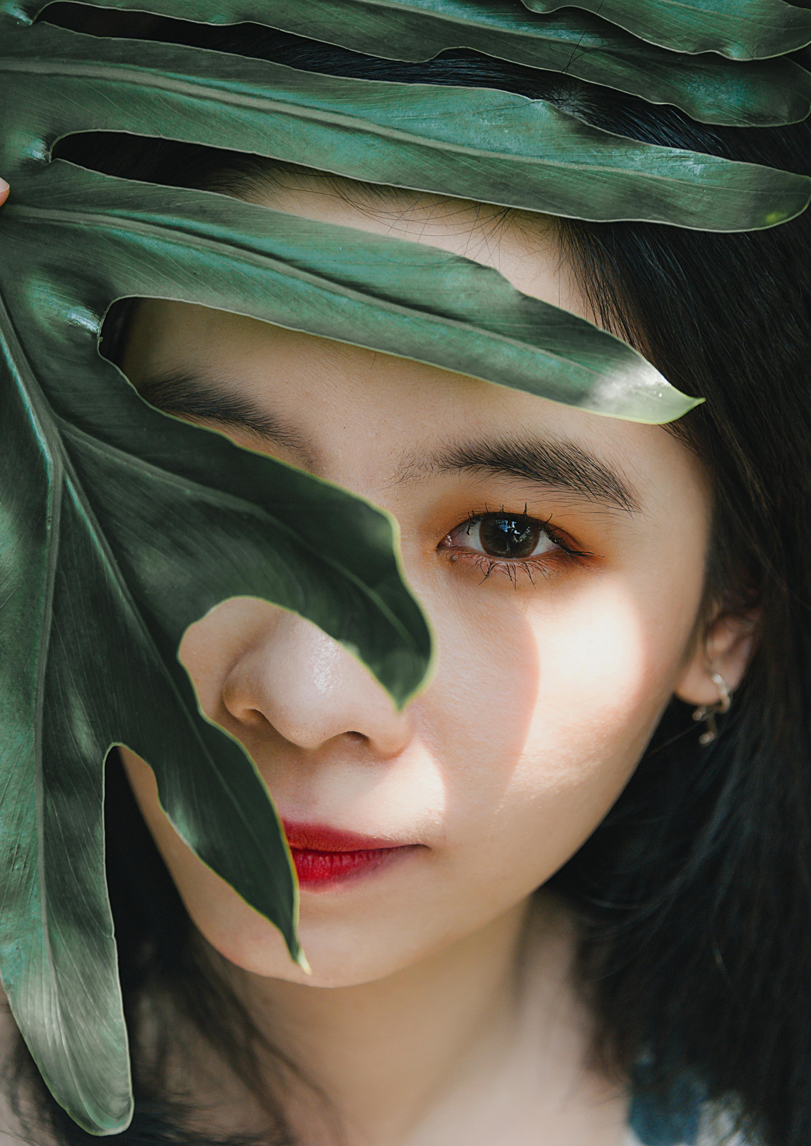 woman face behind leaf