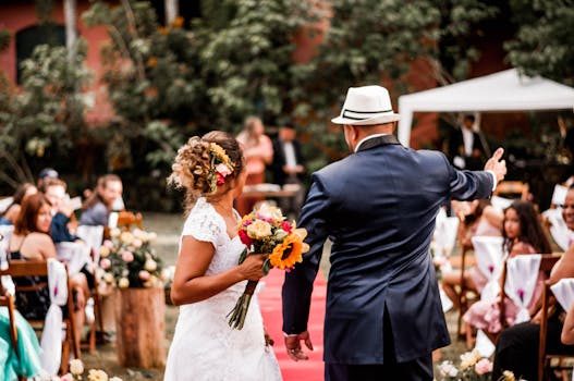 Bride and groom walking down the aisle at an outdoor wedding ceremony.