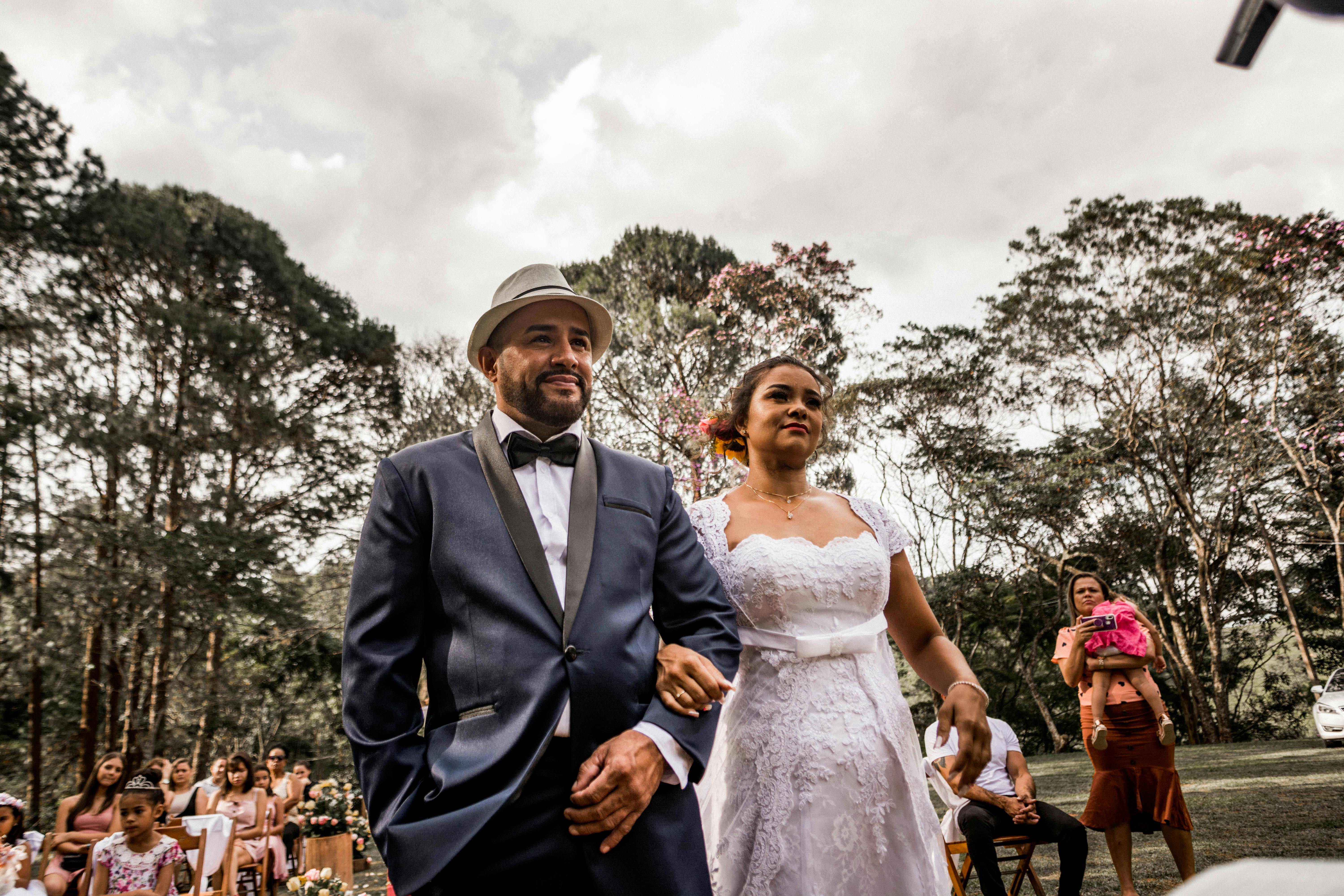 Bride and groom walk down aisle in beautiful outdoor wedding ceremony.