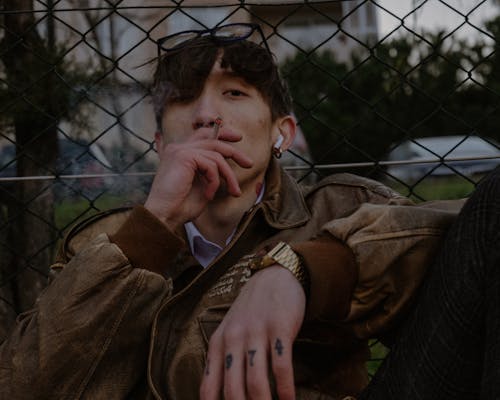 Brunette in Brown Jacket Smoking Cigarette