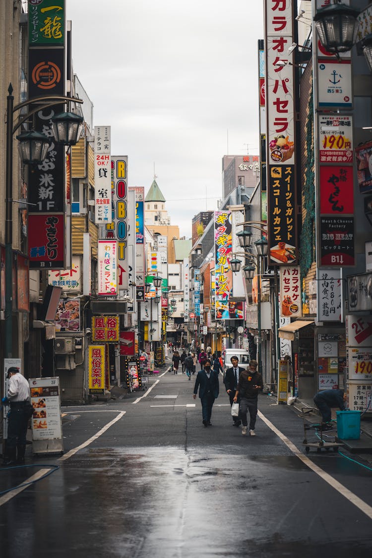 City Street With Shops Signs On Buildings